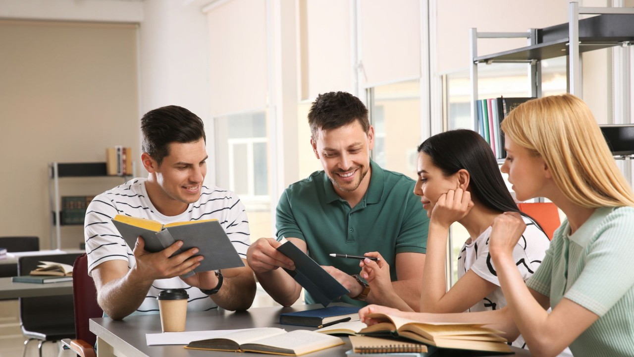 Group discussing books and summaries in a modern office setting